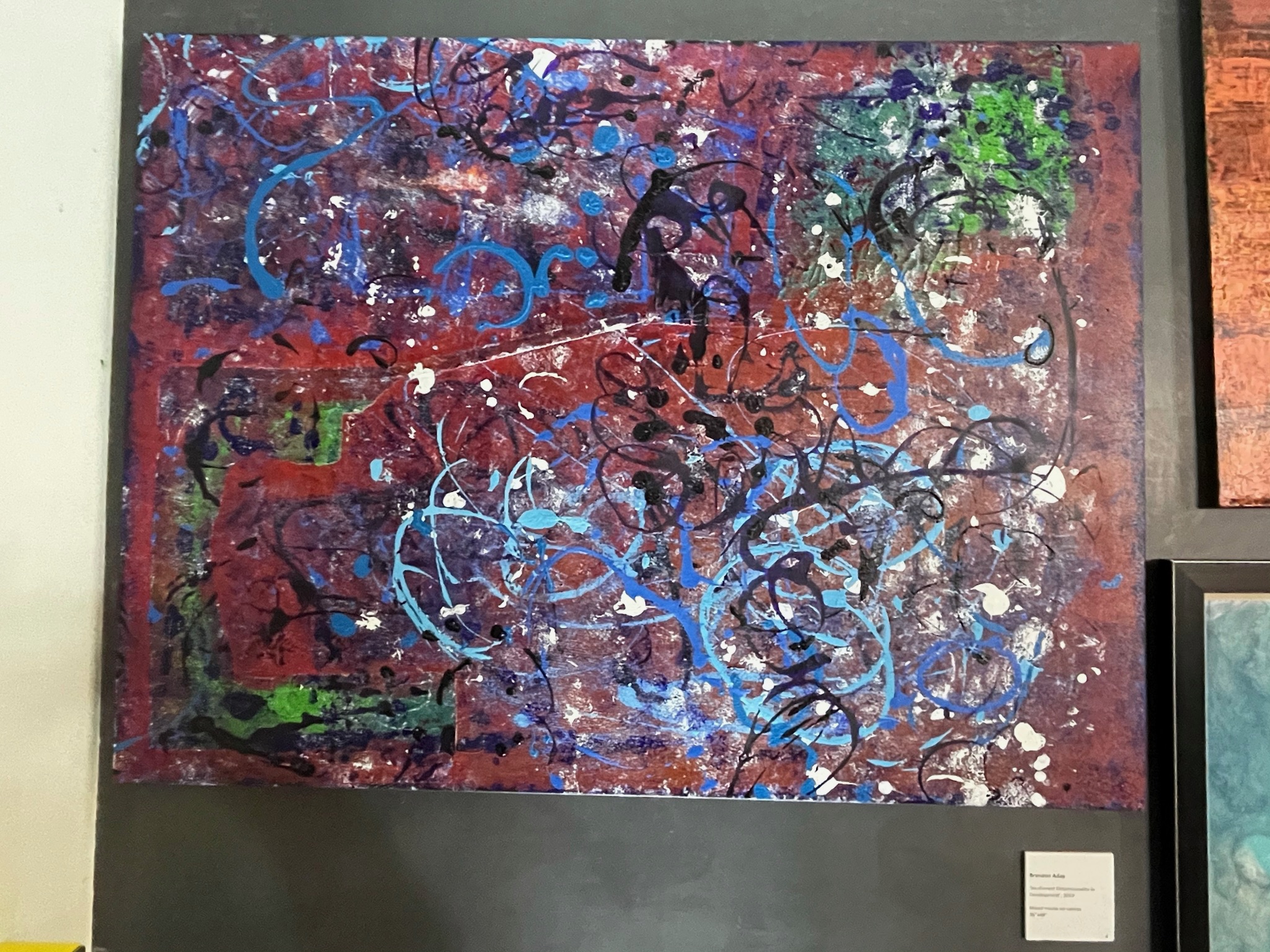 A burgundy ground crossed with vivid blue line work and white splatter.