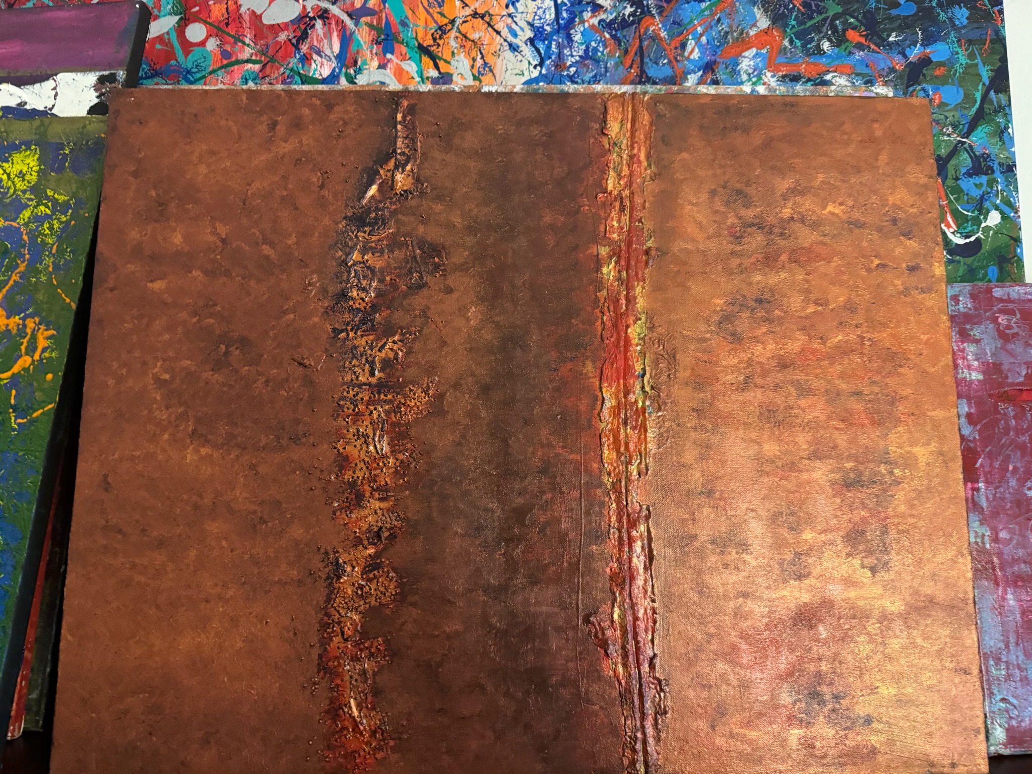 A copper-bronze panel split by a single vertical organic vein down its center.