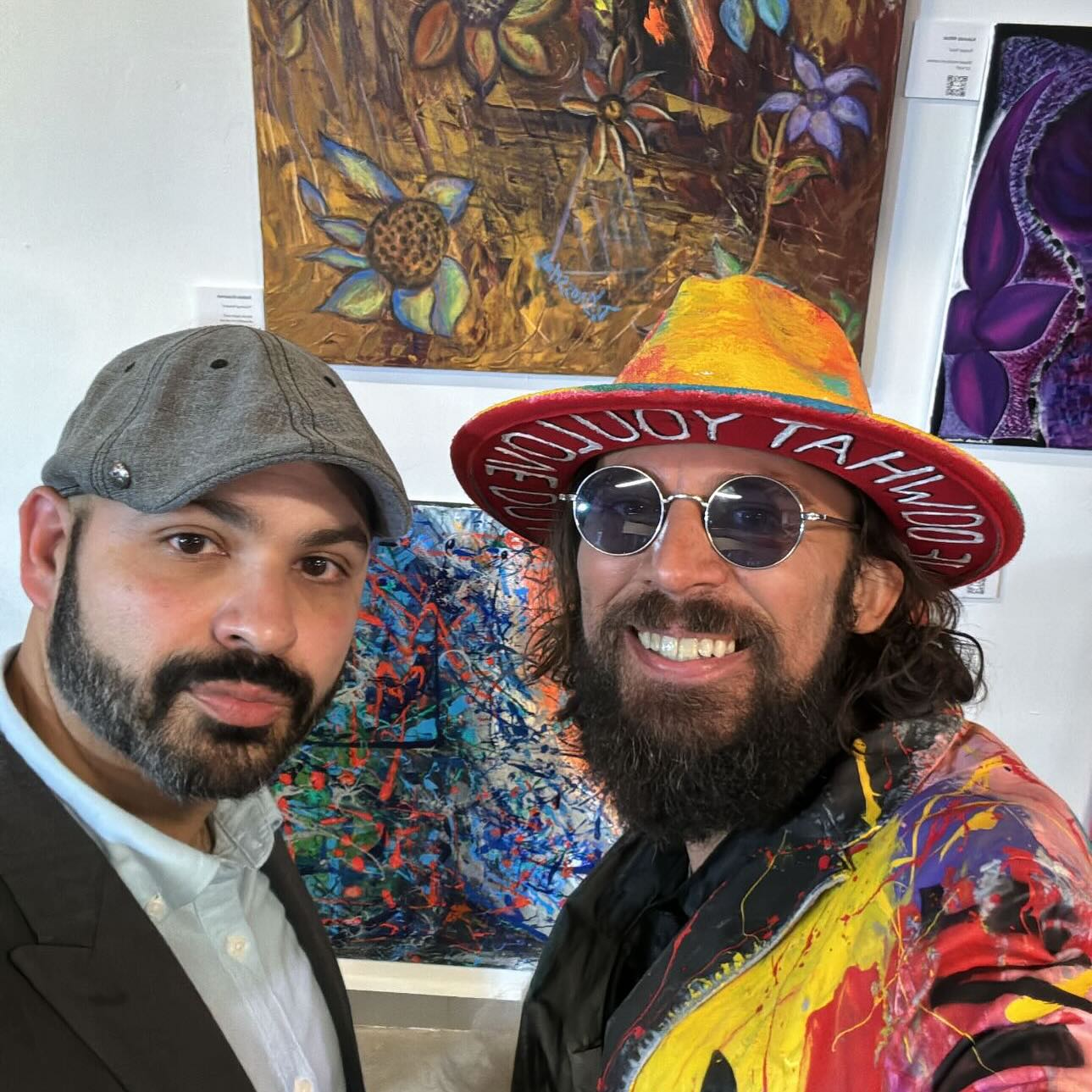 Brandon Aday at a recent exhibition opening, surrounded by his work.